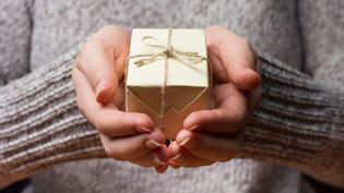 Person holding a small present