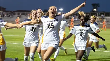 Women's soccer team celebrates victory on the field