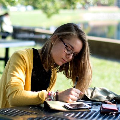 Female student writing on notepad
