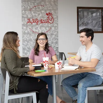 Three students studying at Chick-fil-A